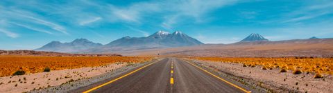 Lone road going to the mountains